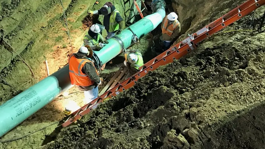 A pipeline crew working a tie-in at night to hold the schedule